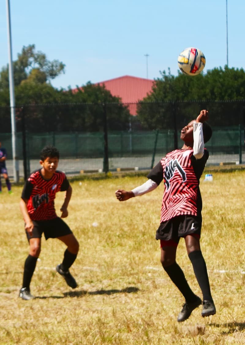 Shosholoza attacker holding off a defender